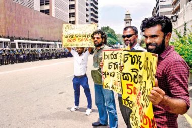 

Four people were seen holding placards outside
the Central Bank of Sri Lanka this week.

They demanded that salaries for other state employees, too, be increased.


